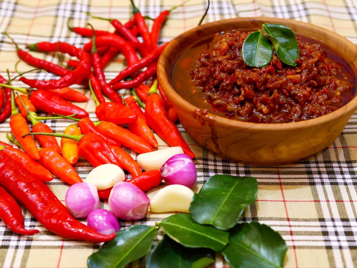 Fresh raw palapa, a pounded relish of scallion bulbs, ginger and red chilli in a bowl
