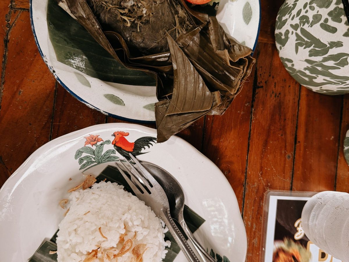 Junay, coconut rice wrapped in banana leaf parcels, served with boiled egg